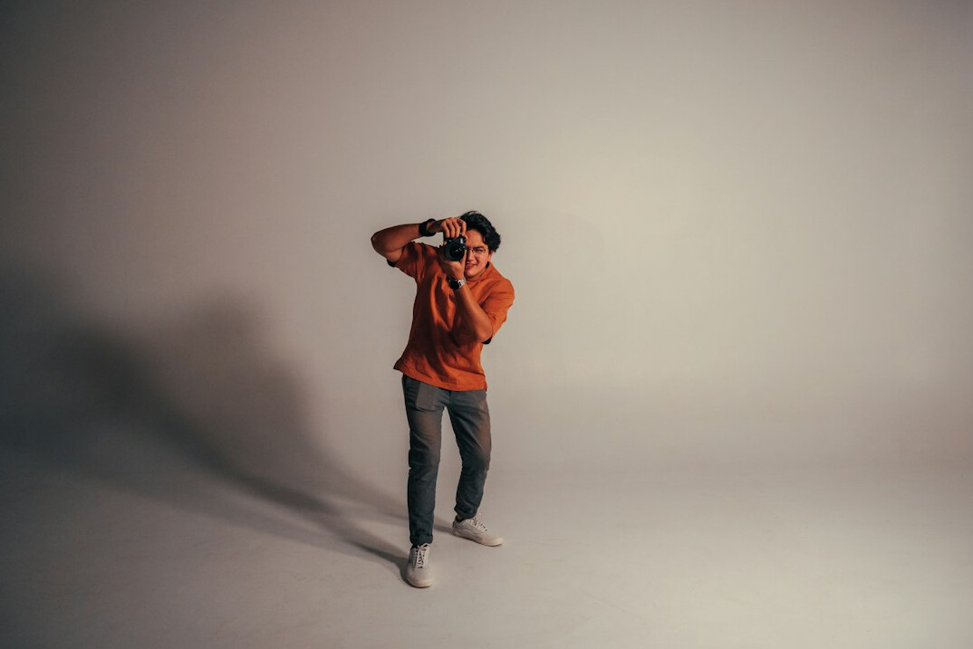 Studio portrait of a young man videographer
