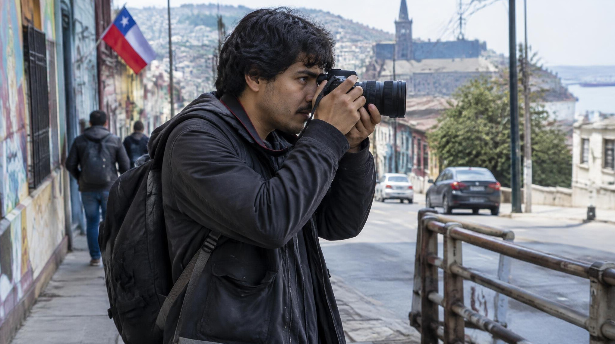 Photographer holding a camera on a city street